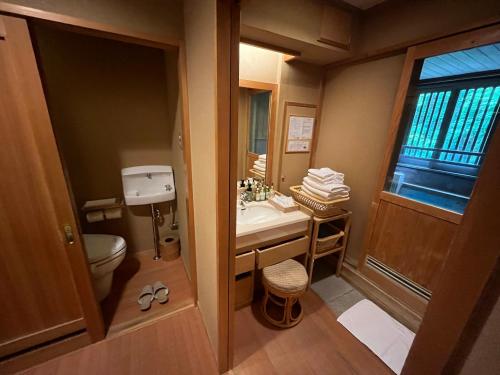 a small bathroom with a sink and a toilet at Jozankei Daiichi Hotel Suizantei in Jozankei