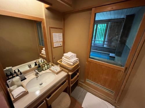 a bathroom with a sink and a window at Jozankei Daiichi Hotel Suizantei in Jozankei