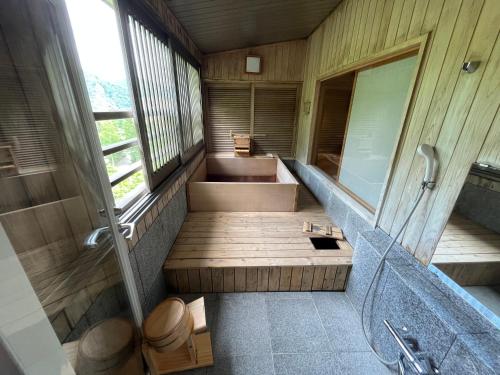 a bathroom with a tub and a toilet and a sink at Jozankei Daiichi Hotel Suizantei in Jozankei