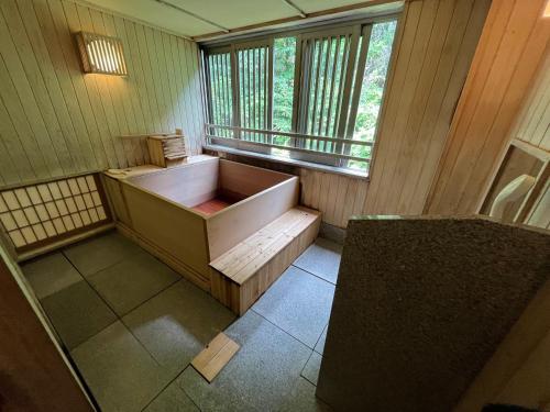 an empty bathroom with a tub and a window at Jozankei Daiichi Hotel Suizantei in Jozankei