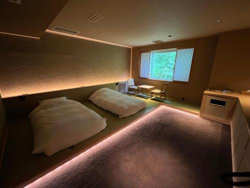 a room with two beds with lights on it at Jozankei Daiichi Hotel Suizantei in Jozankei
