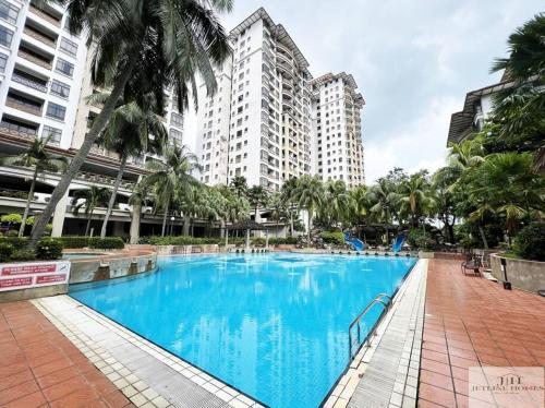 a large blue swimming pool with tall buildings in the background at Central Condo 2pax/1room/Wi-fi/frnt Mahkota Parade in Melaka