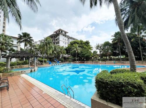 a large blue swimming pool in front of a building at Central Condo 2pax/1room/Wi-fi/frnt Mahkota Parade in Melaka