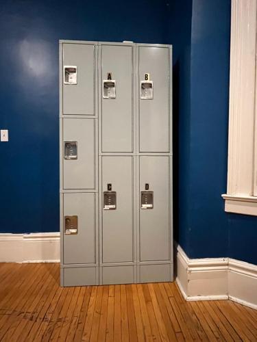 a group of lockers in a room with a blue wall at 49 Hostel in Toronto