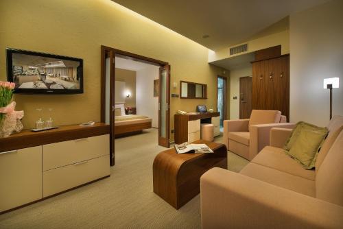 a large living room with a couch and a living room at Wellness Hotel Diamant in Hluboká nad Vltavou