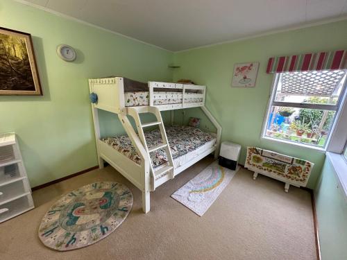 a bedroom with two bunk beds and a window at Lucky house in Auckland