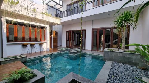 a swimming pool in the middle of a house at Namdur Villa Sariwangi - Tropical Villa in Bandung With Private Pool in Bandung
