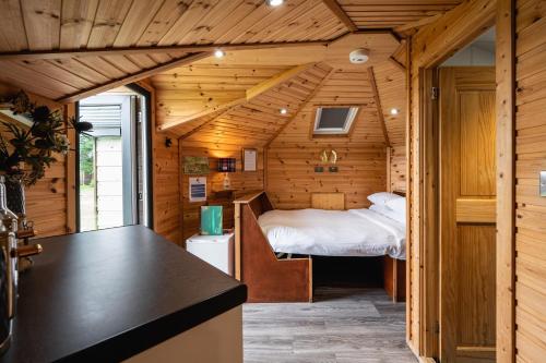 a small room with a bed in a cabin at Delny Glamping and Farm Animals in Invergordon