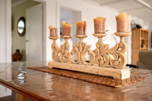 a wooden candle holder sitting on top of a table at Elusive Penguin in Bicheno