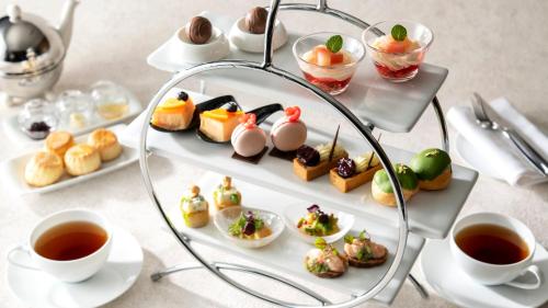 a tray of food on a table with cups of tea at InterContinental Yokohama Pier 8 by IHG in Yokohama