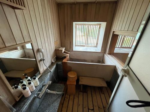 a small bathroom with a tub and a toilet at Jozankei Daiichi Hotel Suizantei in Jozankei