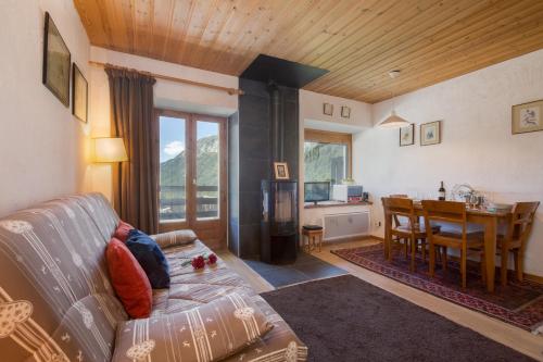 a living room with a couch and a table at Résidence Igloo 3 ski in-ski out - Happy Rentals in Le Tour