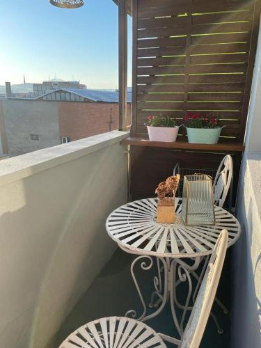 a table and two chairs on a balcony with a table at Aliseo Theater 2 in Drobeta-Turnu Severin