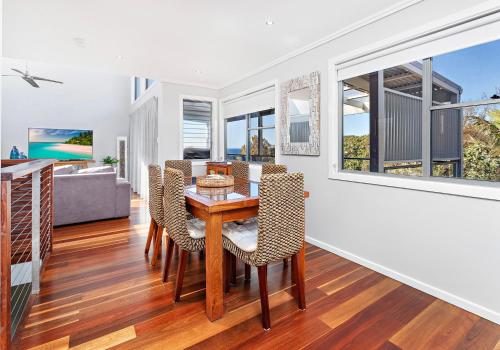 a dining room with a table and chairs at Cookes Haven in Gerringong