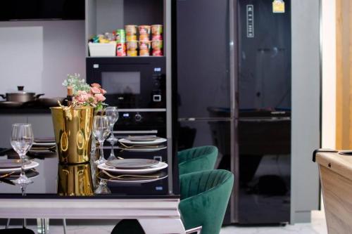 a dining room with a table with plates and a microwave at Napa Pool Villa Pattaya in Nong Prue