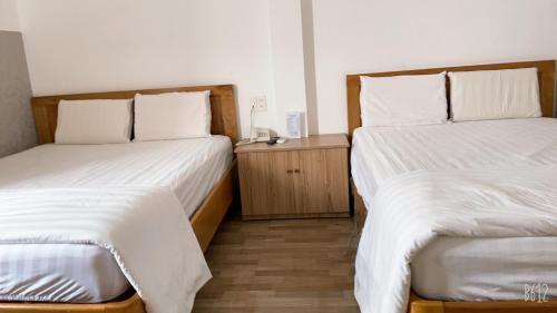 Postel nebo postele na pokoji v ubytování Anh Phat Hotel