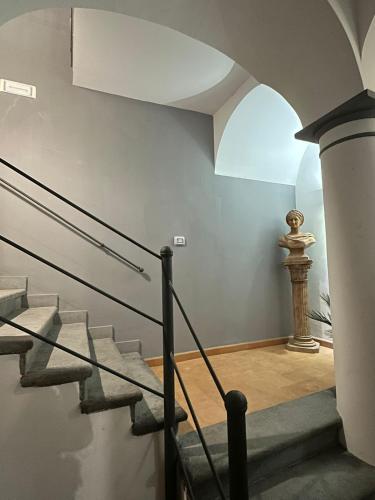 a staircase in a building with a column and a window at Zara Palace in Scafati