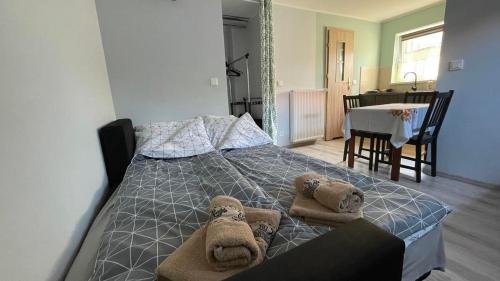 a bedroom with a bed with two teddy bears on it at Apartament U Waldka in Mechelinki