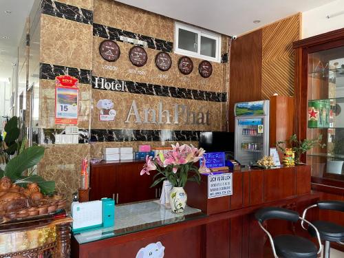 a lobby of a hotel with a counter with flowers at Anh Phat Hotel in Buon Ma Thuot