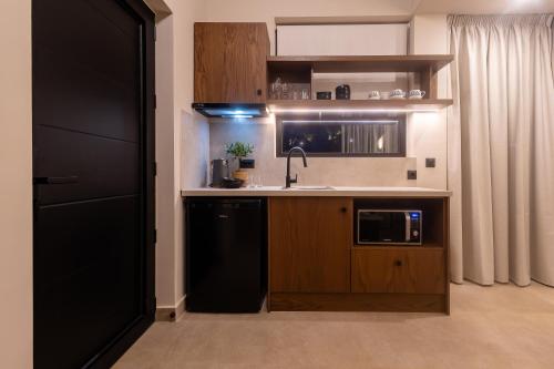 a small kitchen with a sink and a dishwasher at Marni Village in Hersonissos