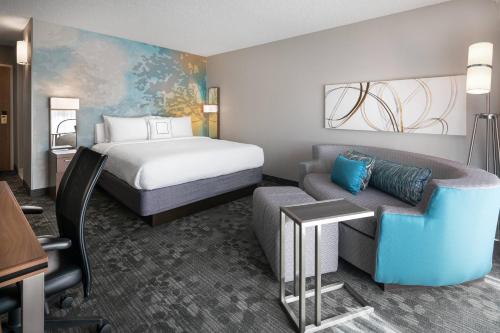 een hotelkamer met een bed en een bank bij Courtyard by Marriott Las Vegas Convention Center in Las Vegas