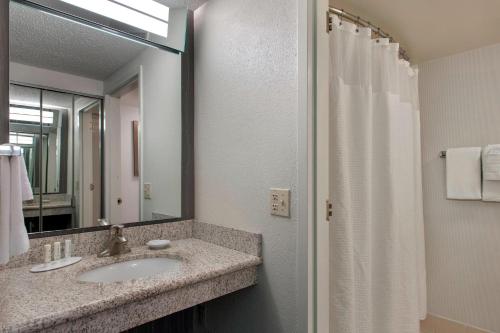 a bathroom with a sink and a mirror at Courtyard by Marriott Princeton in Princeton