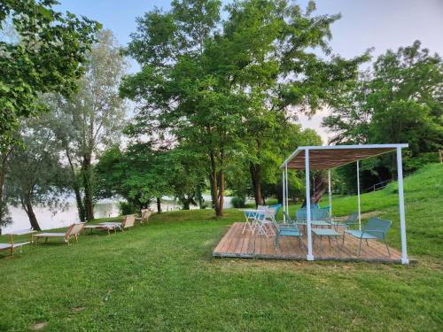 a wooden deck with chairs and a gazebo at Aquasole in Mercallo
