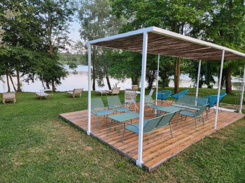 a wooden deck with chairs and a gazebo at Aquasole in Mercallo