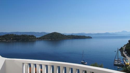 a view of a lake with a boat in the water at Guest House Ruža in Sobra
