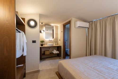 a hotel room with a bed and a sink at Marni Village in Hersonissos