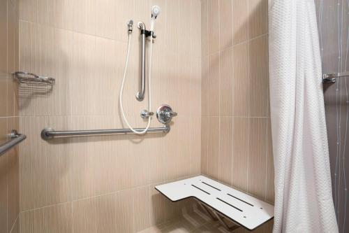 a bathroom with a shower with a toilet in it at Courtyard by Marriott Springfield in Springfield