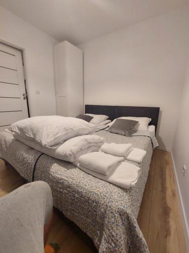 a bedroom with two beds with white sheets and pillows at Bagry Rooms3 LoveKrakow in Kraków