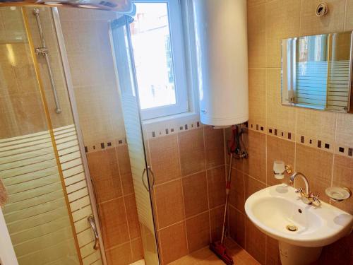 a bathroom with a sink and a shower at VIP apart SVETLANA in Ravda