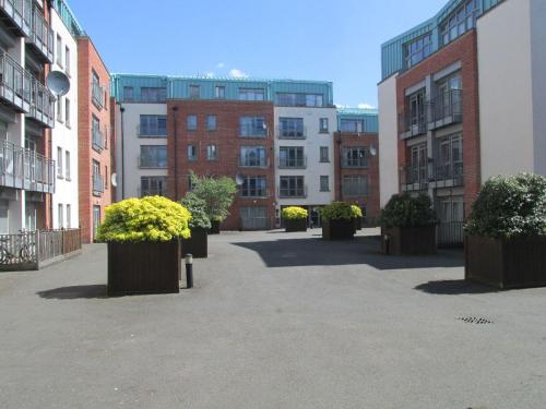 a courtyard of buildings with potted plants in them at CITY CENTRE FLAT IDEAL FOR SHORT AND LONG STAYS! 2 Bedroom Cosy Flat-Coventry City Centre, 7min walk from Train Station! in Coventry