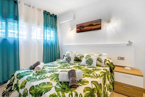 a bedroom with a bed with a tropical themed bedspread at Selene in Calpe