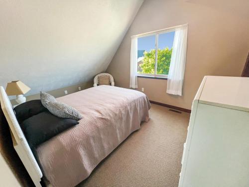 a bedroom with a bed and a window at Bridges Bay Vacation Cabin 33 in Arnolds Park