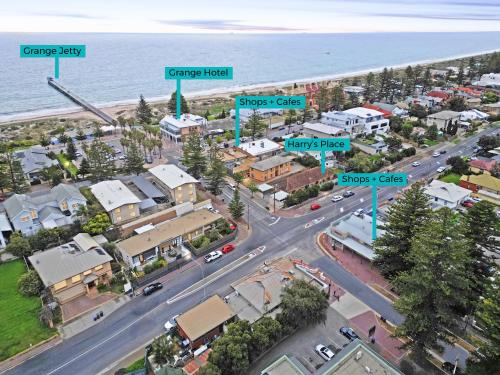 an aerial view of a city with a street at Perfect Cosy Beachside Escape in Grange