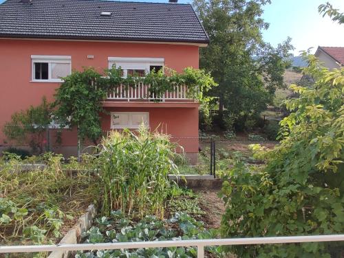 a house with a garden in front of it at Apartman Bor in Livno