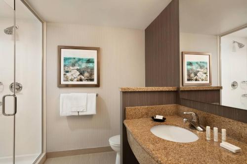a bathroom with a sink and a toilet and a shower at Courtyard by Marriott Middletown Goshen in Middletown