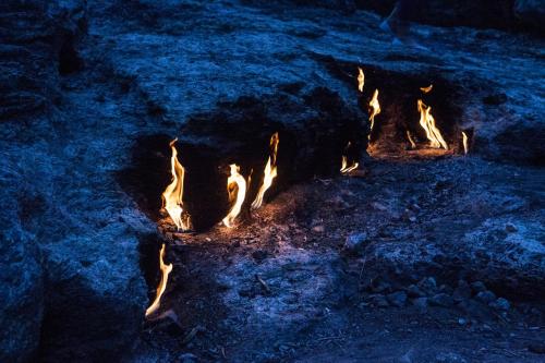 a group of fires are burning in the dirt at Ekinoks Hotel - Adults Only in Cıralı