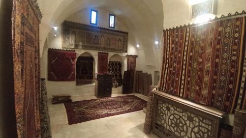 a hallway of a mosque with carpets on the walls at CAPPADOCİA DAİLY WELLNESS MEDİTATİON CENTER in Ürgüp