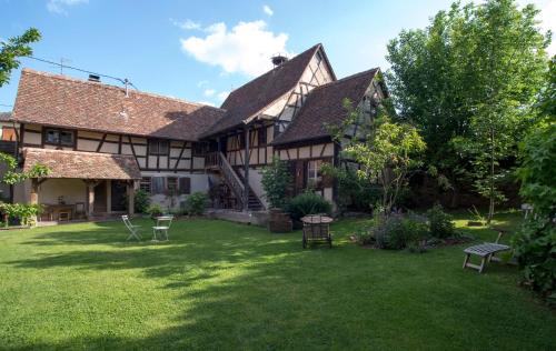 an old house with a yard in front of it at La Ferme de Marie in Rangen