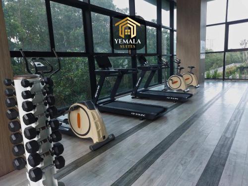 a gym with a row of treadmills in a room at Yemala Suites at Skyloft - Johor in Johor Bahru