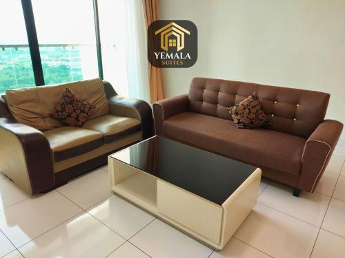 a living room with two couches and a coffee table at Yemala Suites at Skyloft - Johor in Johor Bahru