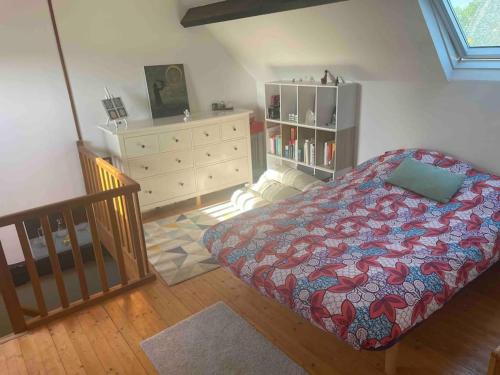 a bedroom with a bed and a dresser at Maison entière, en pleine campagne in Saint-Mars-sur-Colmont