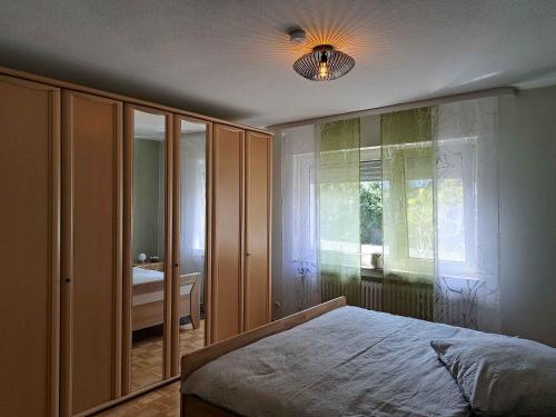 - une chambre avec un lit et une grande fenêtre dans l'établissement Ferienwohnung Blumenau, à Schmallenberg