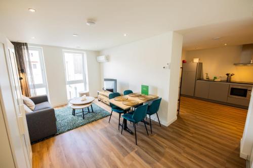 a living room with a table and chairs and a kitchen at Divine 50m2 Apartment - WE39D in Tiel