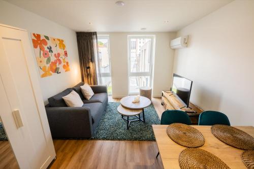 a living room with a couch and a table at Divine 50m2 Apartment - WE39D in Tiel