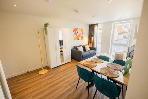 a living room with a table and chairs and a couch at Divine 50m2 Apartment - WE39D in Tiel