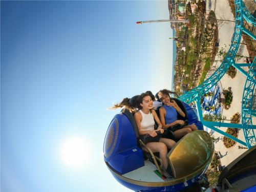 a group of people riding on a roller coaster at Rixos Water World Aktau - Theme Park Free Access in Aktau